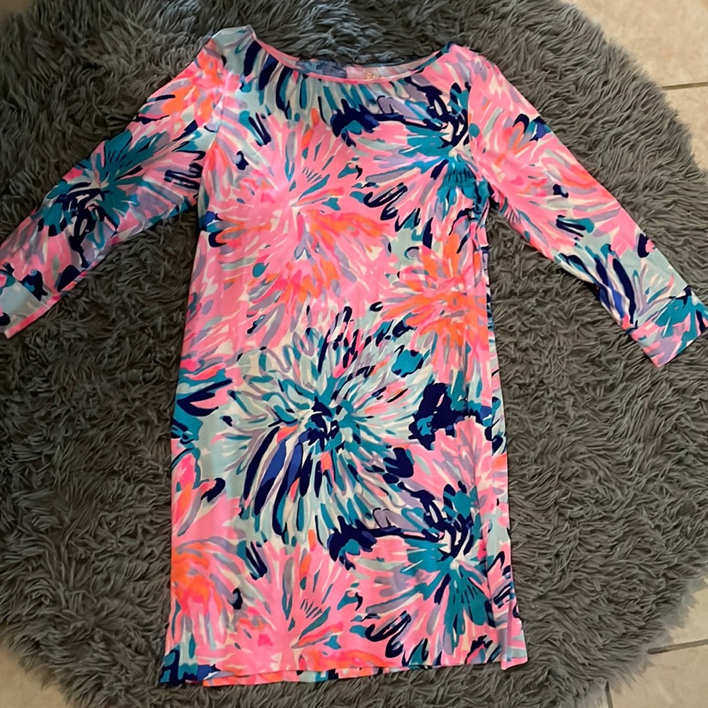 These are some dresses and they are some pink dresses wit sum blue and green